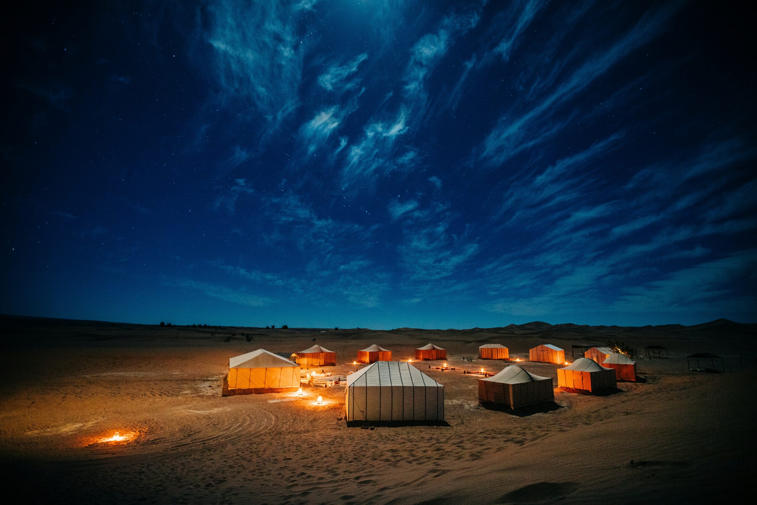 Desert camp tents under a starry sky near Merzouga